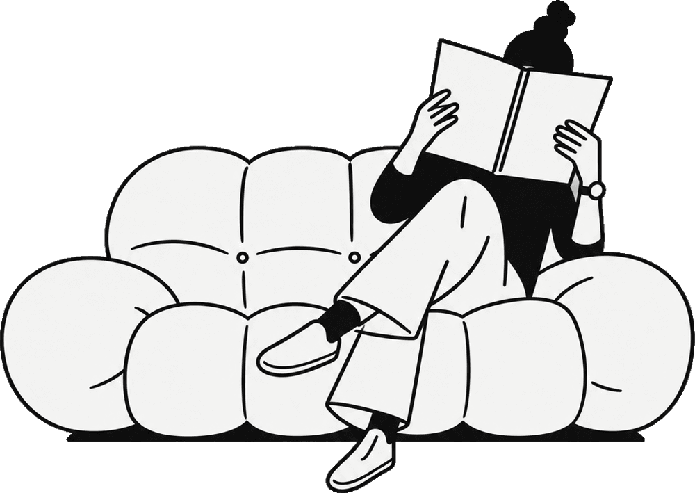 A student reading on a sofa